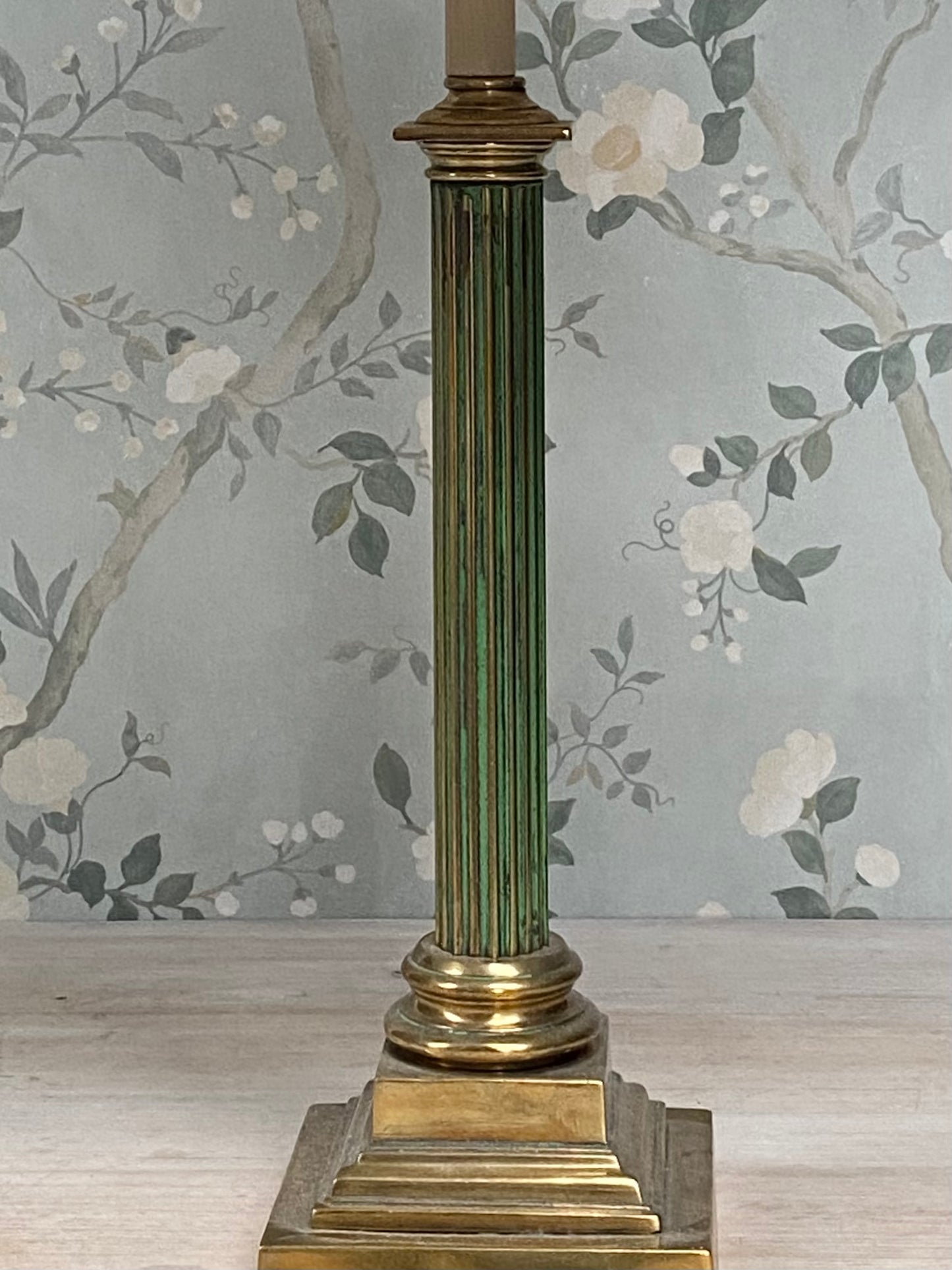 An antique fluted column lamp base with brass and gilt detailing and original green paint.