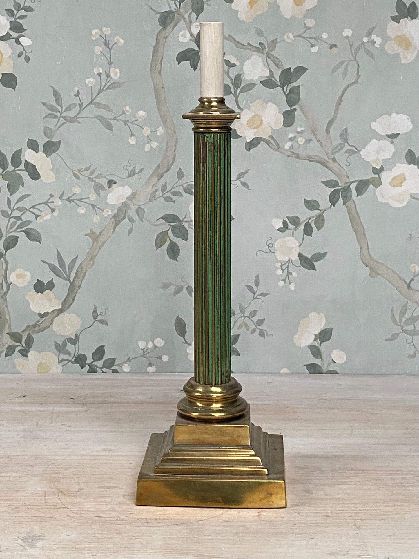 An antique fluted column lamp base with brass and gilt detailing and original green paint.