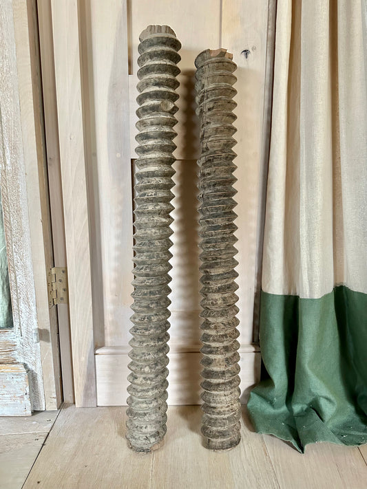 An unusual pair of olive press turning columns