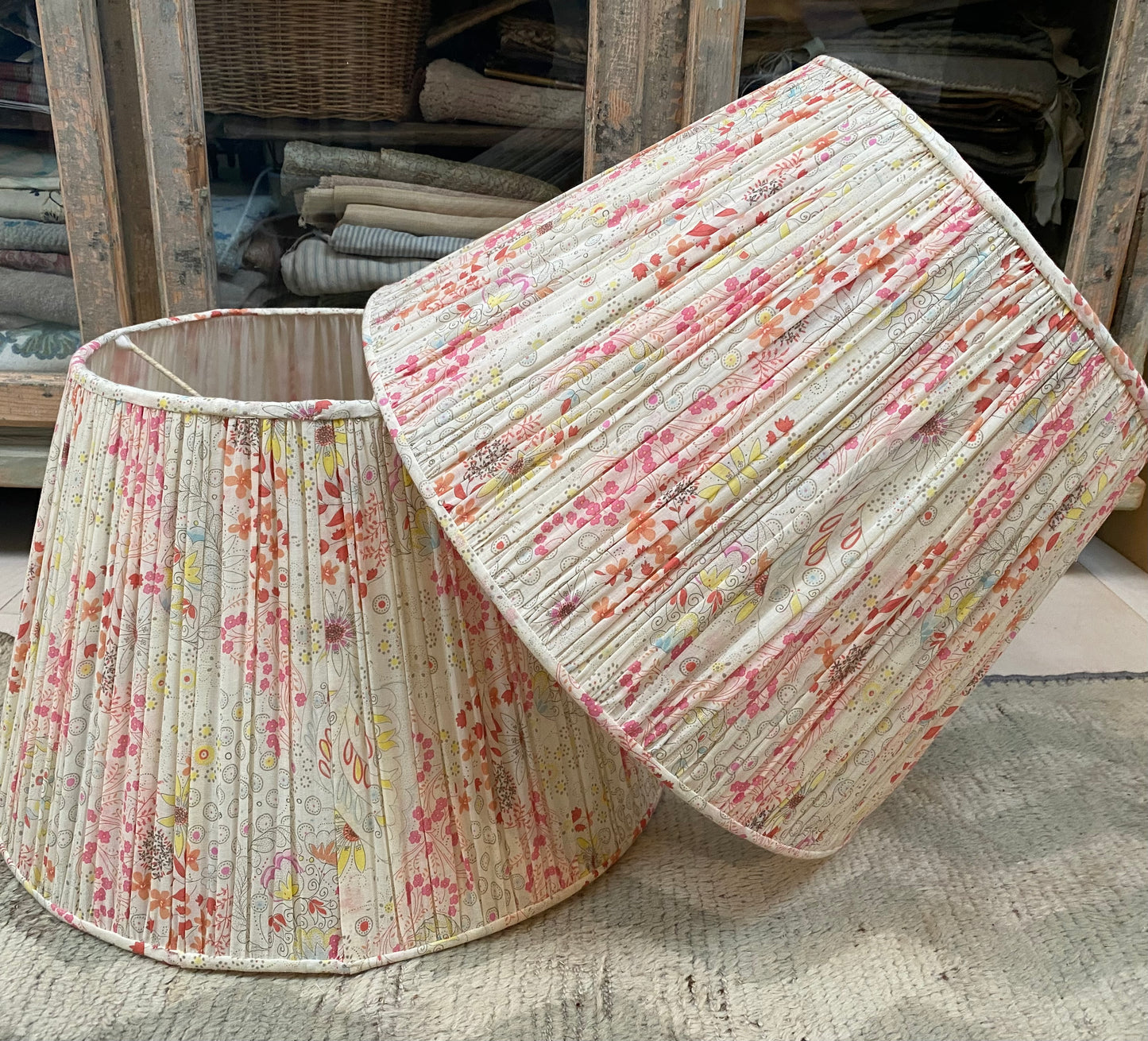 A pair of large gathered lamp shades.