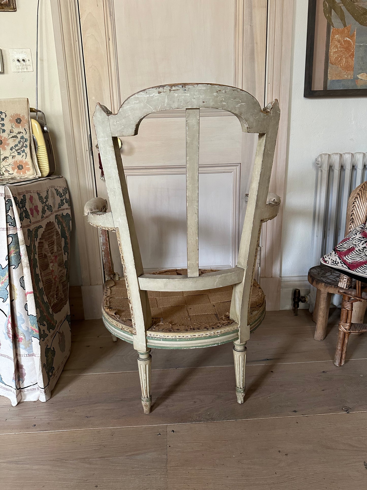 A french chair frame in its original green and off-white paint